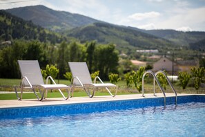 Seasonal outdoor pool, open 9:00 AM to 8:00 PM, pool umbrellas