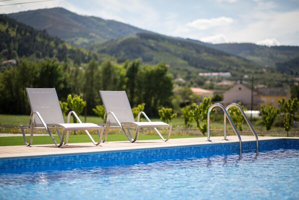 Seasonal outdoor pool, open 9:00 AM to 8:00 PM, pool umbrellas