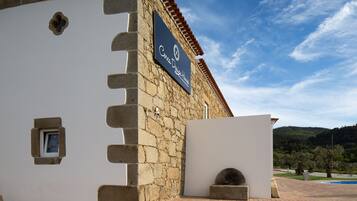 A stone building with a sign reading "Casa De Dios House".