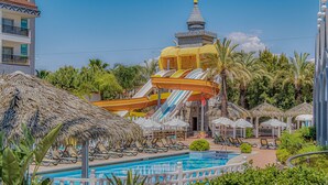 A resort with a water park, including slides and a pool area with sun loungers. - Well Palace Side - All Inclusive (Manavgat)