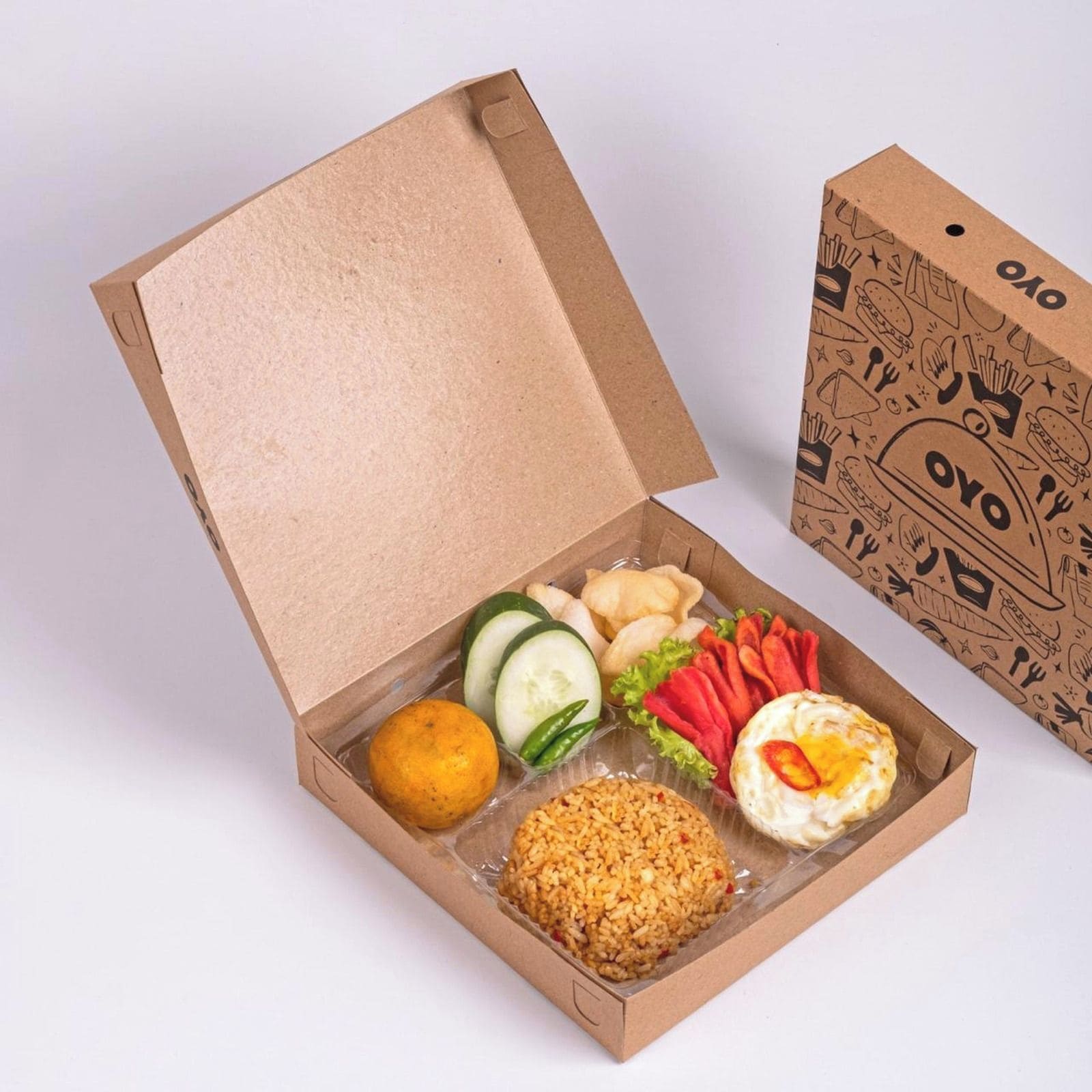 A cardboard box with a variety of food items including rice, vegetables, and a fried egg.