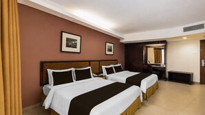 A hotel room with two beds, a large mirror, and a picture on the wall. - Sunday Kuantan Near Cherating Beach Formerly Residence Inn (Cherating)