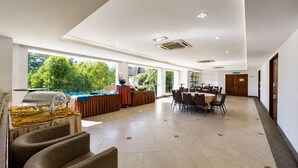 A spacious indoor area with a buffet setup, large windows, and a long corridor. - Sunday Kuantan Near Cherating Beach Formerly Residence Inn (Cherating)