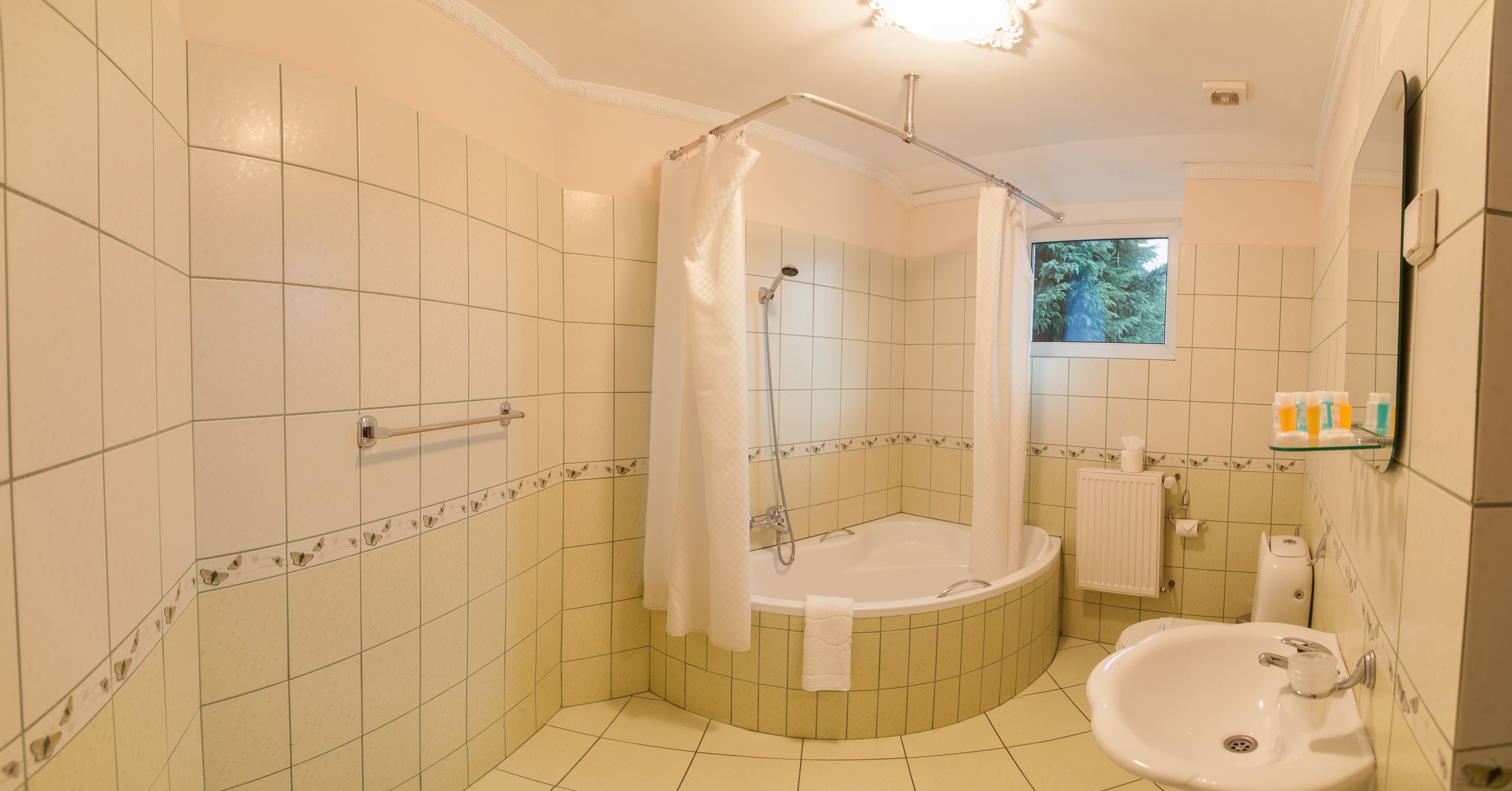 A bathroom with a bathtub, a shower, and a sink.