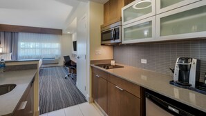 A modern kitchen with a built-in microwave, coffee maker, and a dishwasher. - Best Western Plus Sawridge Suites (Fort McMurray)