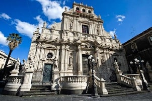 Un edificio storico con architettura elaborata, un ingresso imponente e una scalinata che conduce all'ingresso principale.