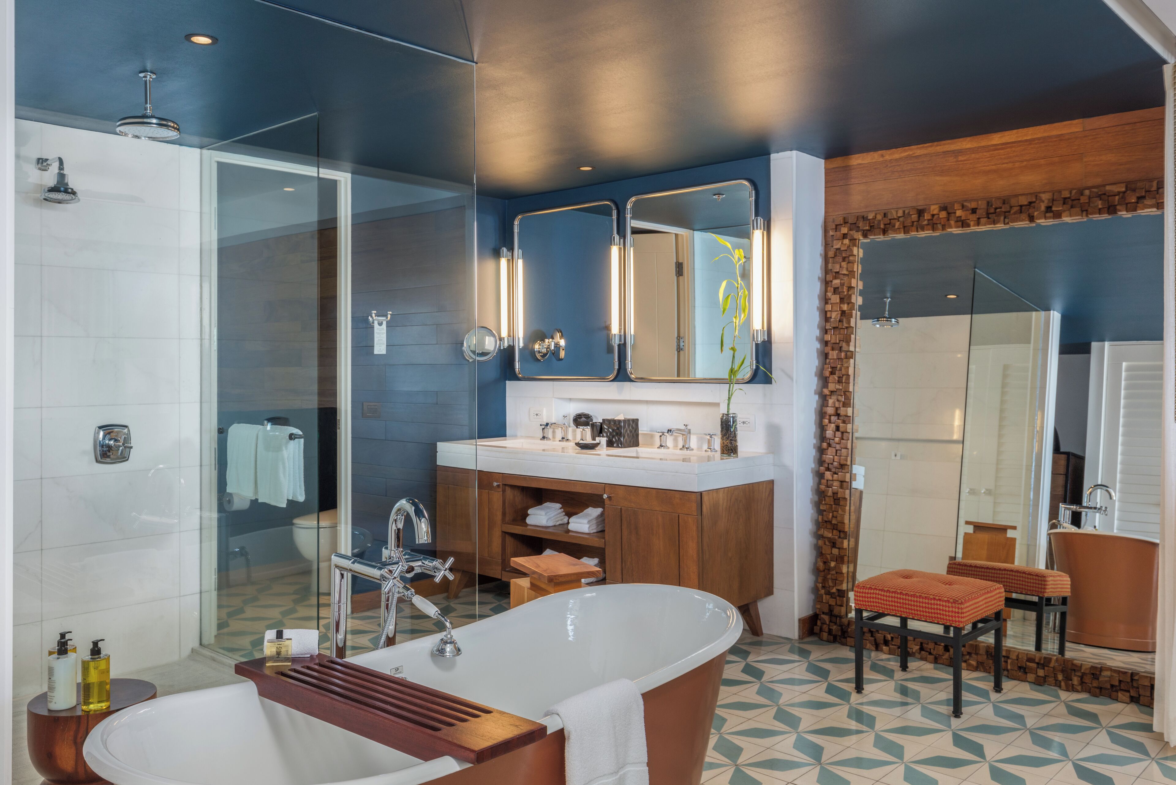 A modern bathroom with a freestanding bathtub, a glass-enclosed shower, and a wooden vanity.