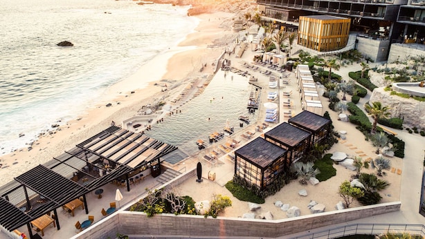 A beachfront hotel with a pool area, outdoor seating, and a view of the ocean. - The Cape, A Thompson Hotel, by Hyatt (Cabo San Lucas)