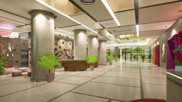 A modern hotel lobby with a reception desk, large pillars, and potted plants.