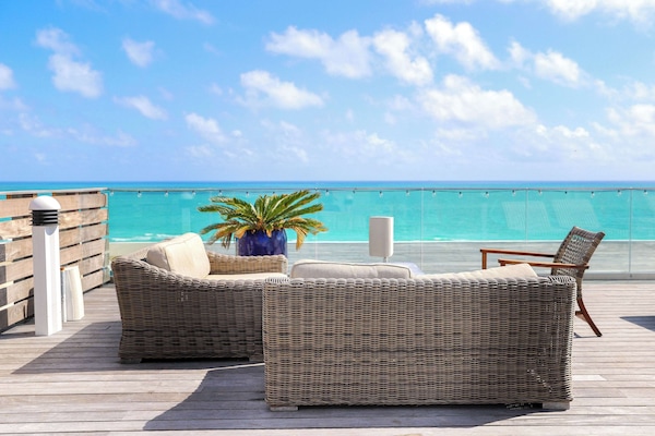 On the beach, beach cabanas, sun loungers, beach towels