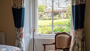A room with a window, a chair, and a bed. - Leven House (Crieff)