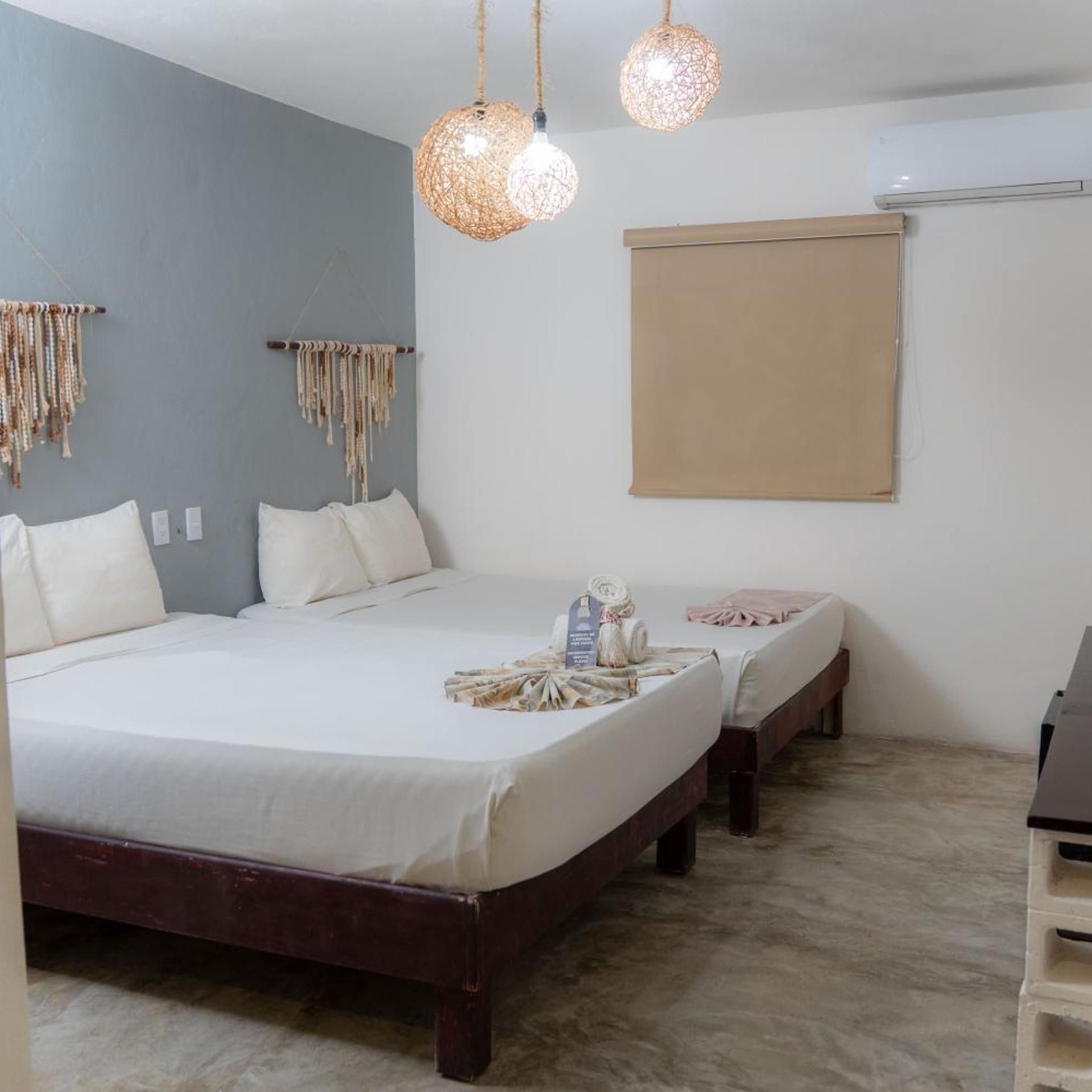 A bedroom with a large bed, two bedside tables, and a wardrobe.