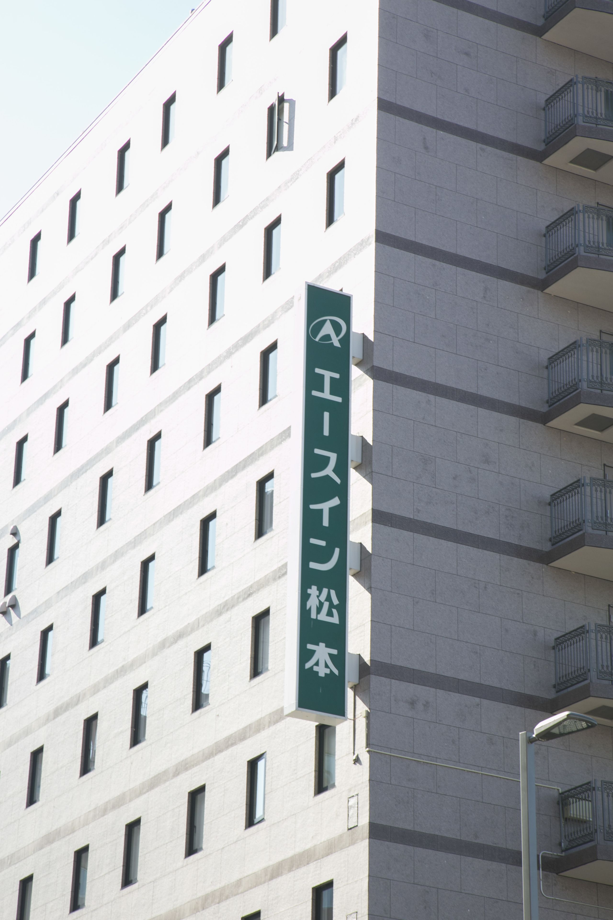 A multi-story building with a green sign indicating "EAST SIDE" and "EAST SIDE HOTEL".
