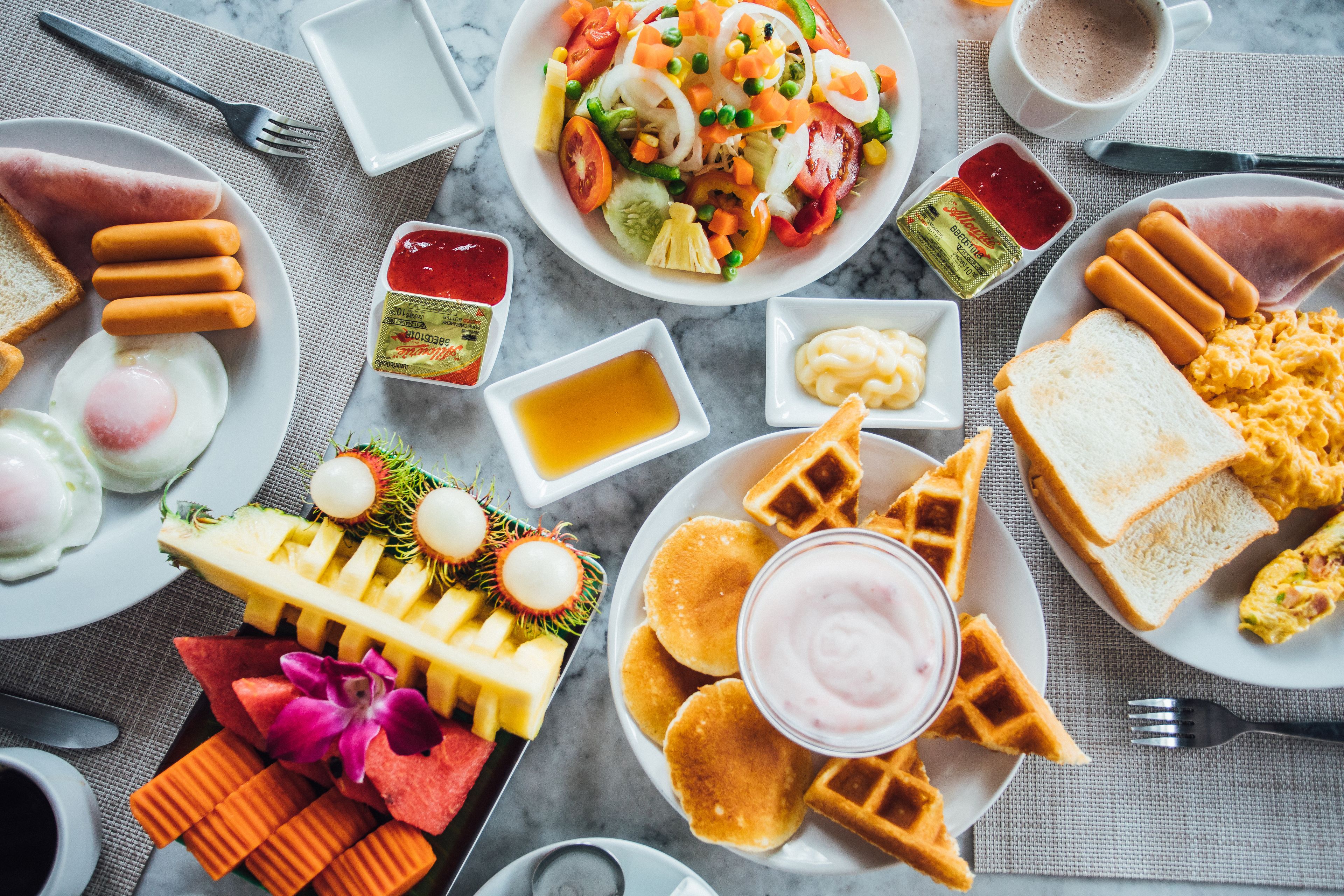 A breakfast buffet with various food items and condiments.