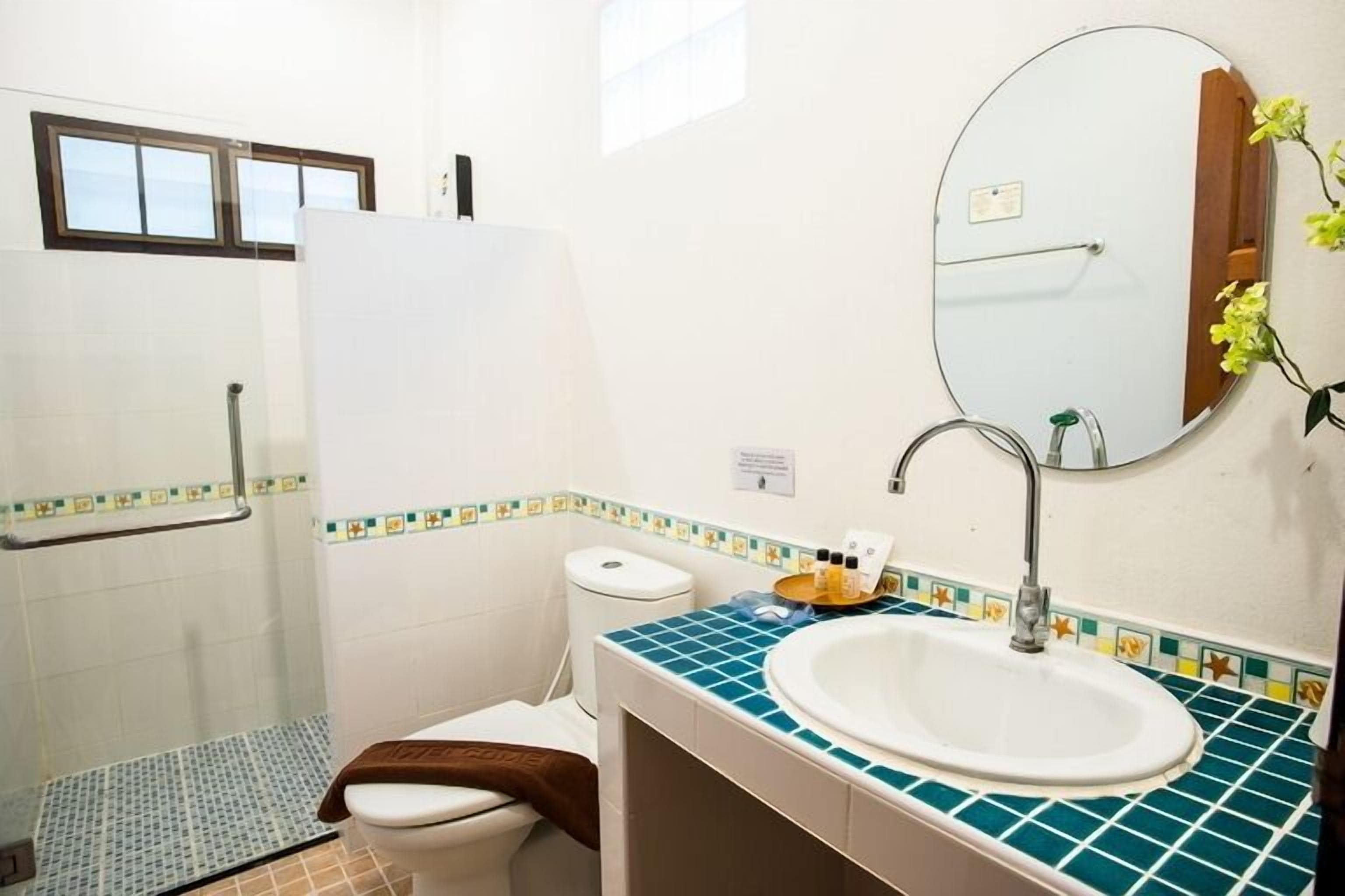 deluxe room | bathroom | shower, free toiletries, hair dryer, slippers
