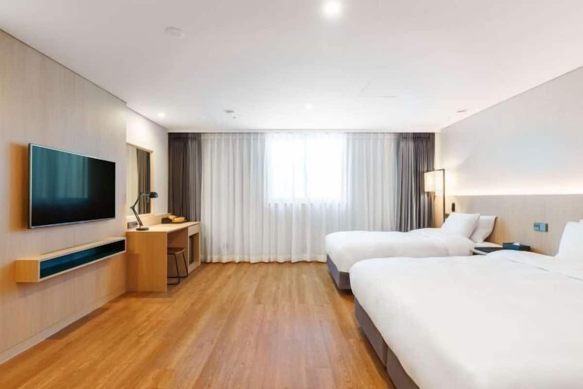 Premium bedding, desk, laptop workspace, soundproofing