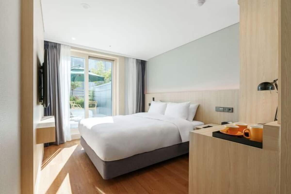 Premium bedding, desk, laptop workspace, soundproofing