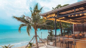 A beachside restaurant with outdoor seating overlooking the ocean. - Sand Dunes Chaolao Beach Resort (Tha Mai)