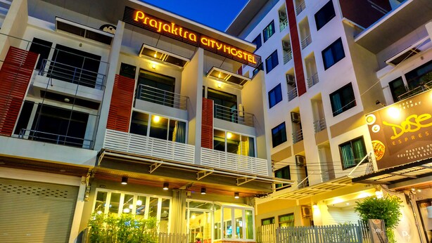 A multi-story building with a sign reading "Rajakarta City Hostel". - Prajaktra City Hostel (Udon Thani)