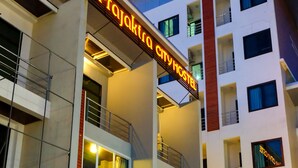 A multi-story building with a sign reading "Prajakta City Hostel." - Prajaktra City Hostel (Udon Thani)