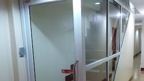 A modern interior with a glass door leading to a staircase. - Walking Street Guest House (Pattaya)