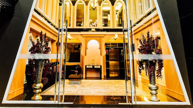 The entrance of the Baron Hotel with a grand chandelier and ornate decor. - Baron Zotel Bangkok (Bangkok)