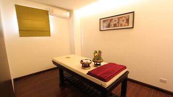 Relax in a serene space with a table, air conditioning, and a framed picture.