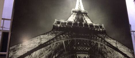 A large, detailed mural of the Eiffel Tower at night.