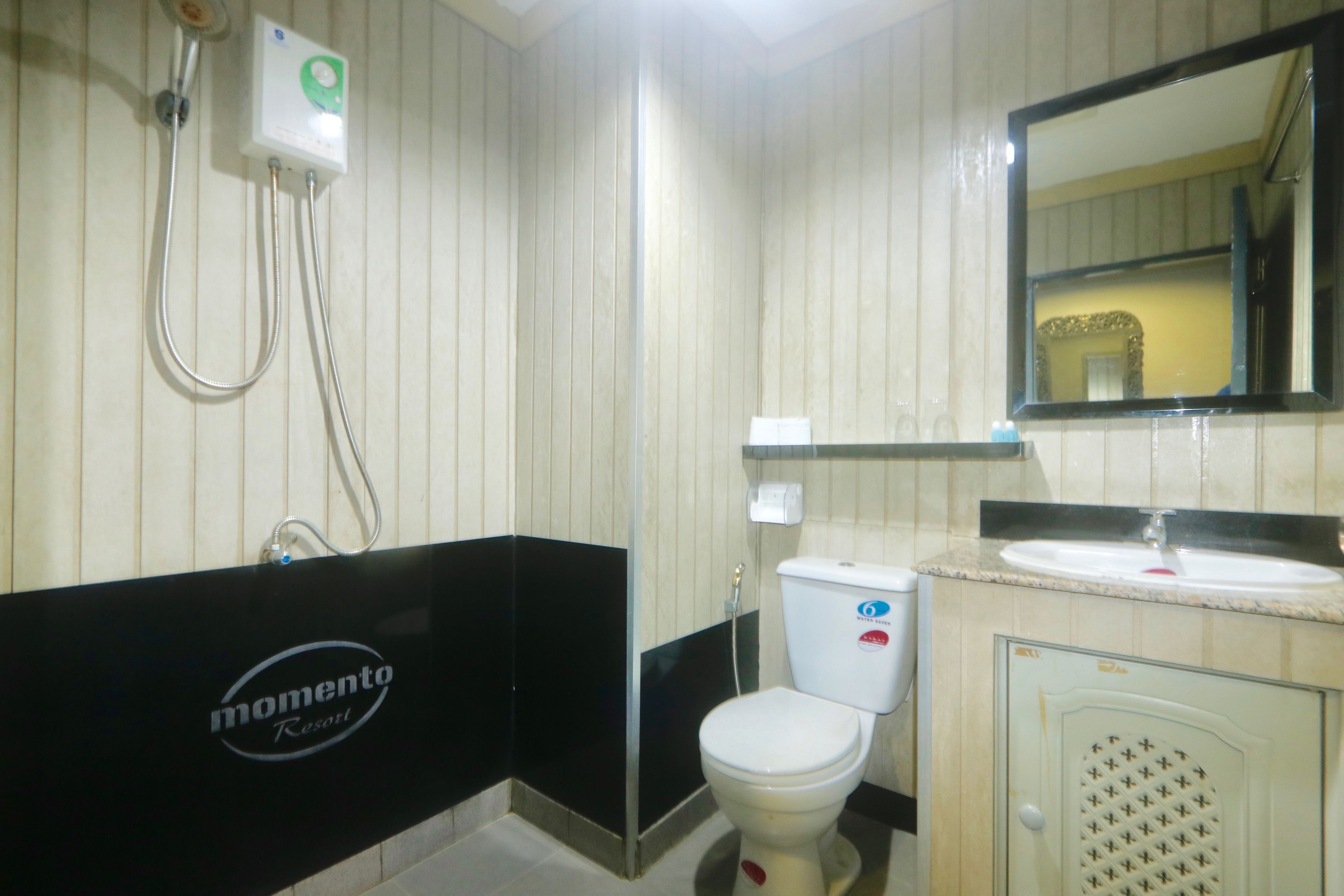 A bathroom with a shower, toilet, and sink.