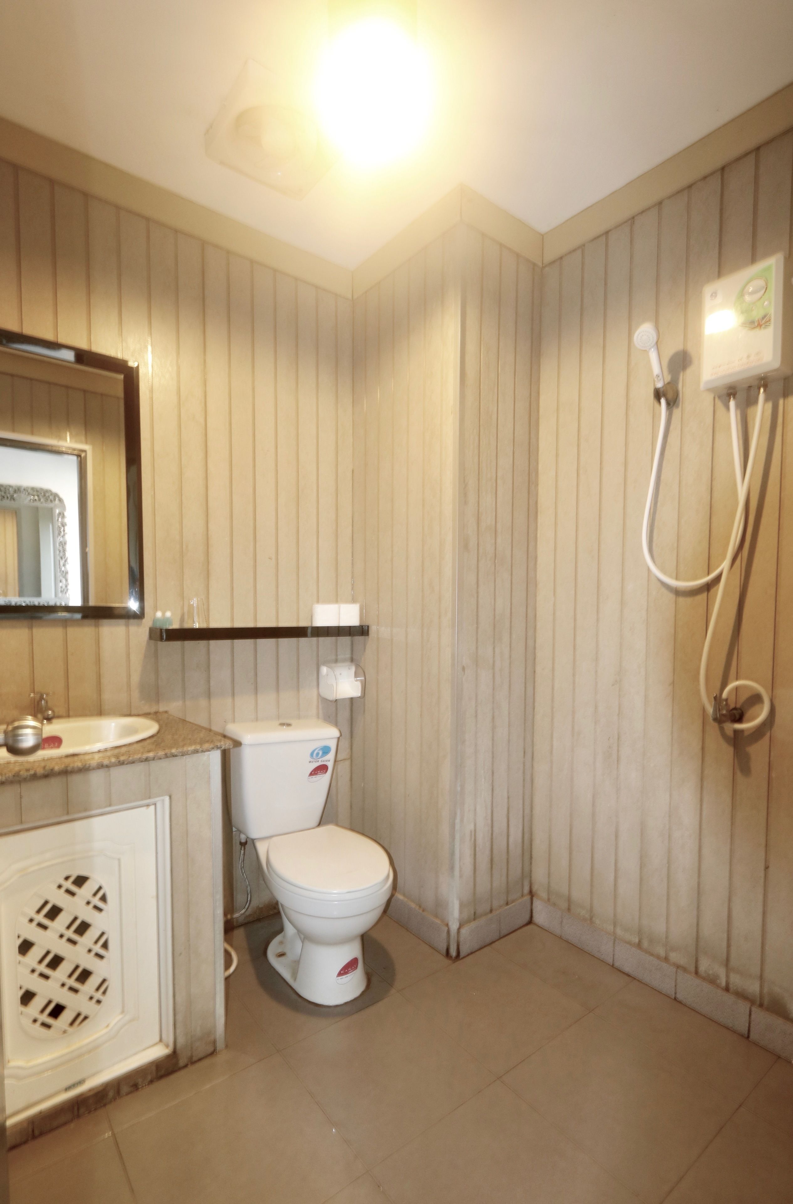 A bathroom with a toilet, sink, and shower.
