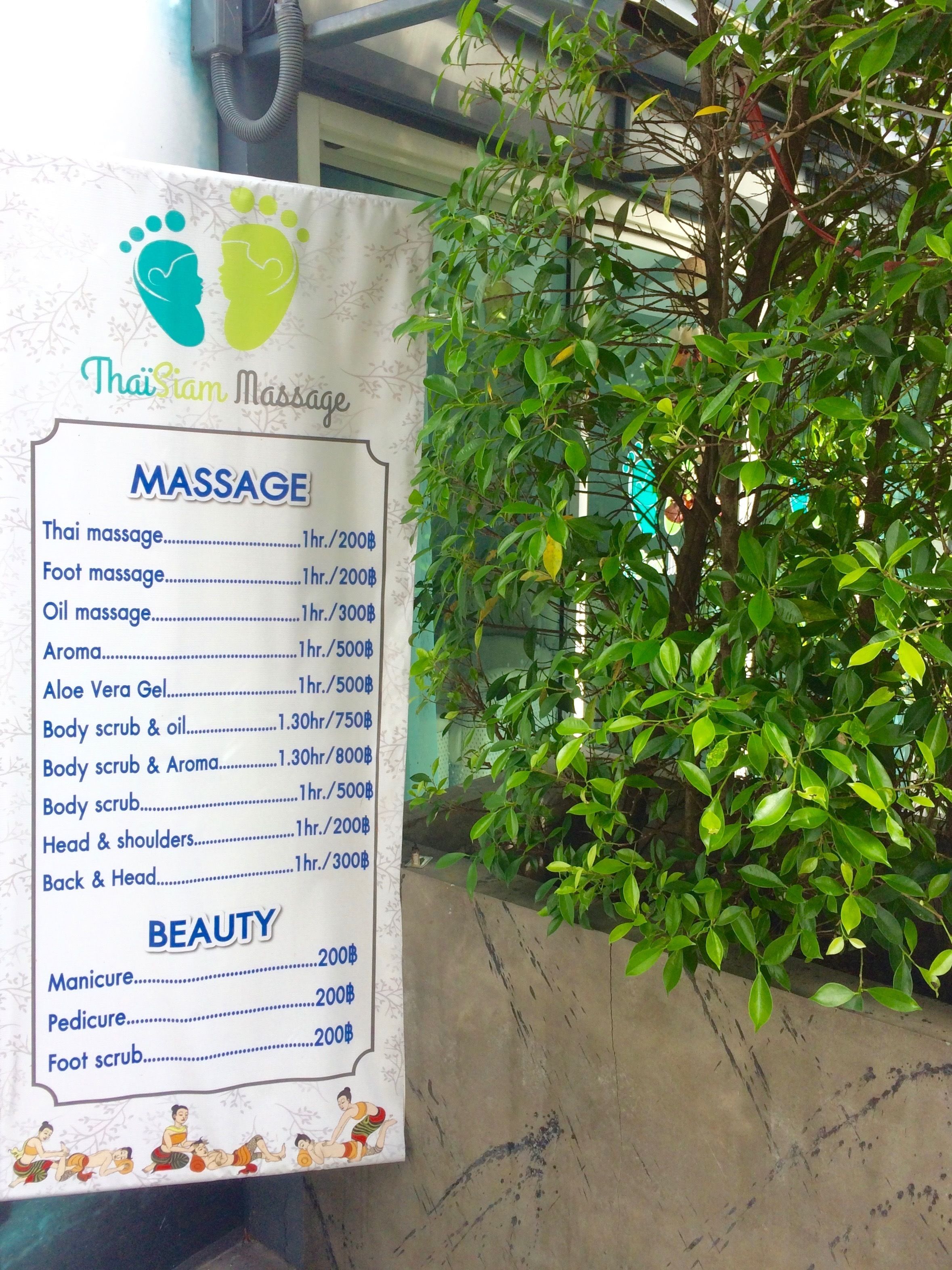 A sign listing massage and beauty services with prices.