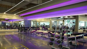 A gym with various exercise equipment, mirrors, and a floor with numbered tiles. - PRS Hotel by Sojourn (Pattaya)