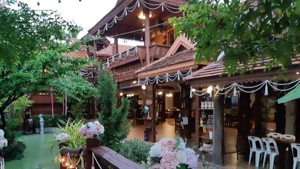 A traditional wooden building with a covered outdoor seating area, decorated with string lights and floral arrangements. - Montri Resort Donmuang Bangkok (Bangkok)