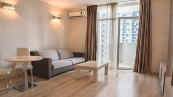 Apartment, 2 Bedrooms | Living room | Flat-screen TV, pay films