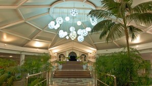 A grand staircase with a geometric patterned floor, surrounded by lush greenery and palm trees, leading to a dark doorway at the top. - Relaxia Lanzasur- All Inclusive (Yaiza)