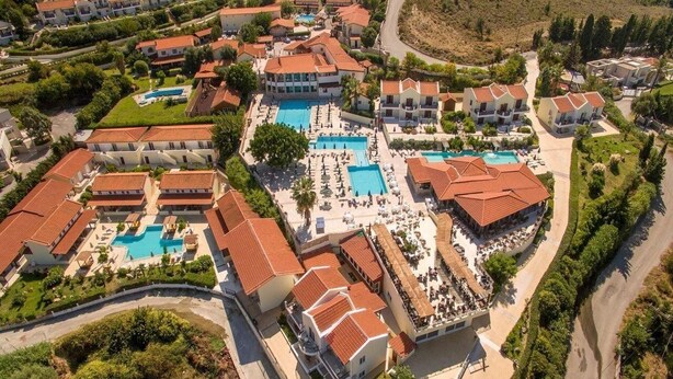 An aerial view of a resort with multiple swimming pools, villas, and landscaped areas. - Aegean View Aqua Resort (Kos)