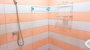 A bathroom with a shower, a towel rack, and a toilet. - Sea Beach Koh Larn 3 (Koh Lan)