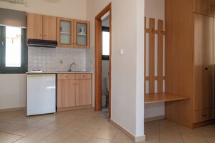 A kitchen with wooden cabinets, a dishwasher, and a refrigerator.
