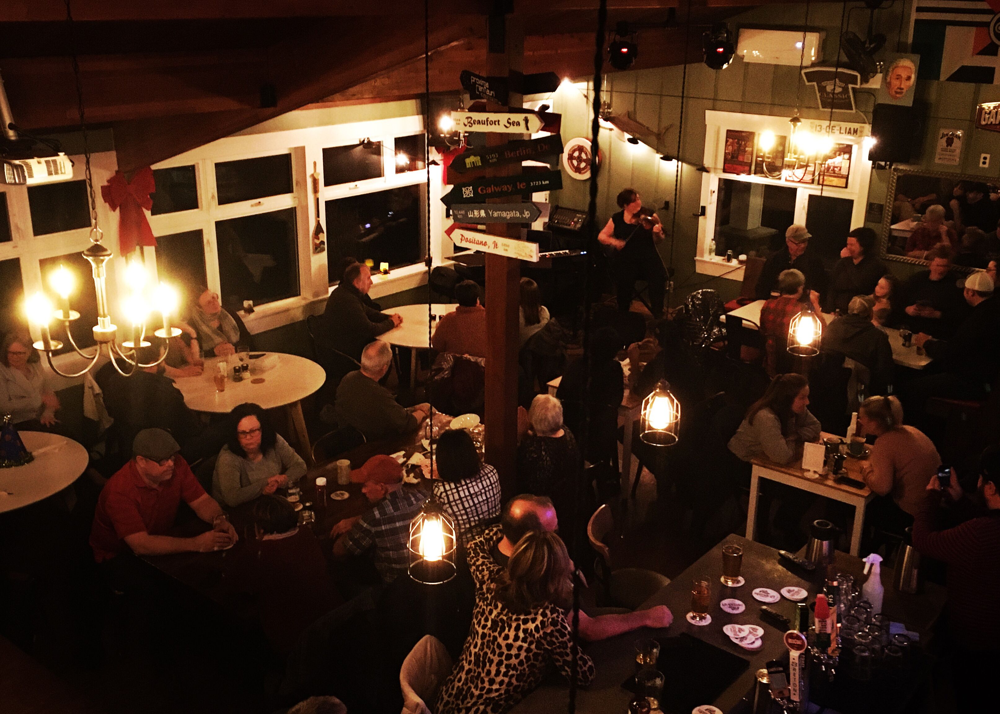 A crowded bar with tables and patrons.