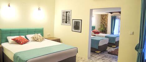 A bedroom with a bed, bedside tables, an air conditioning unit, and a mirror.