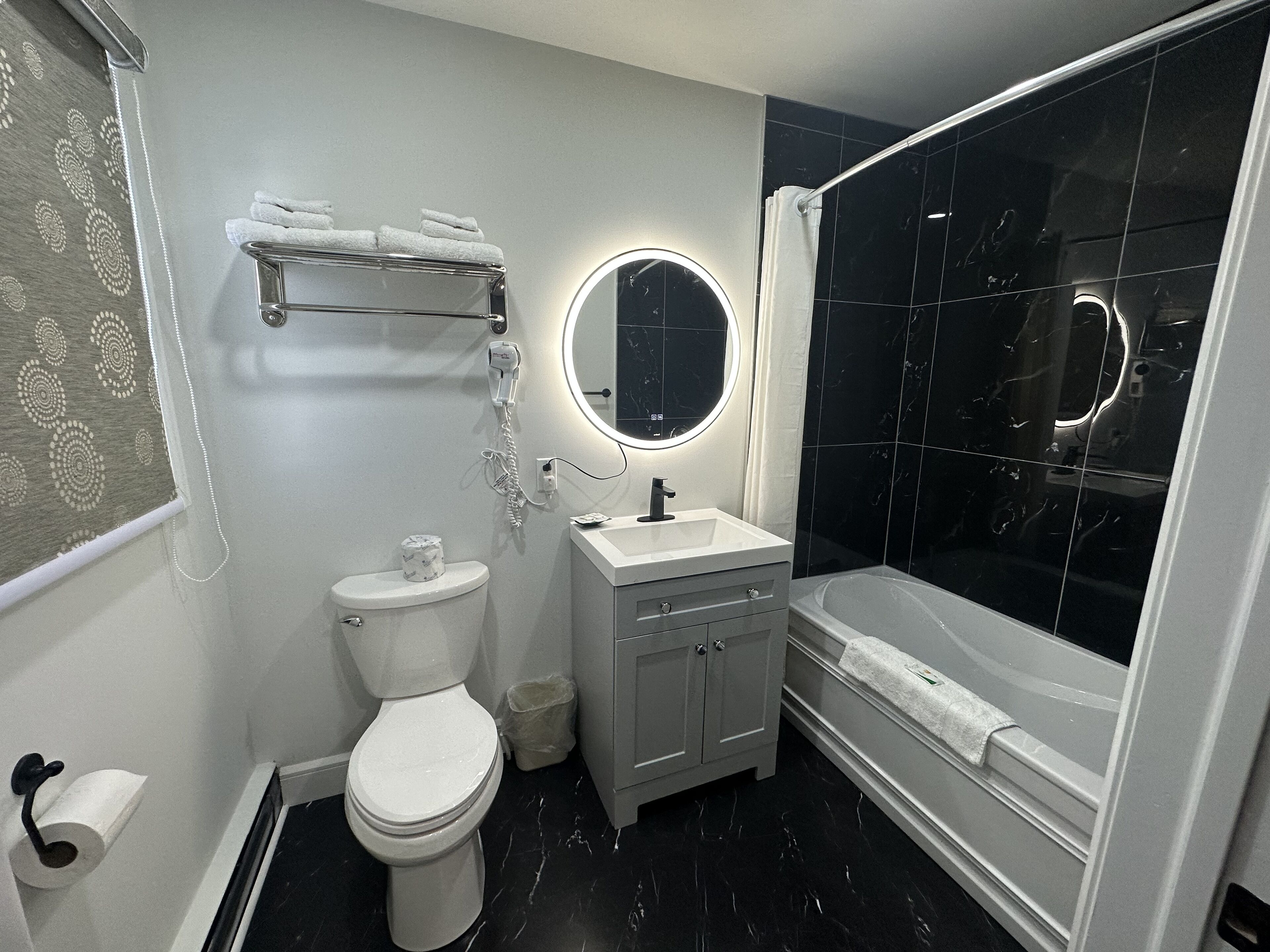A bathroom with a toilet, sink, and bathtub.