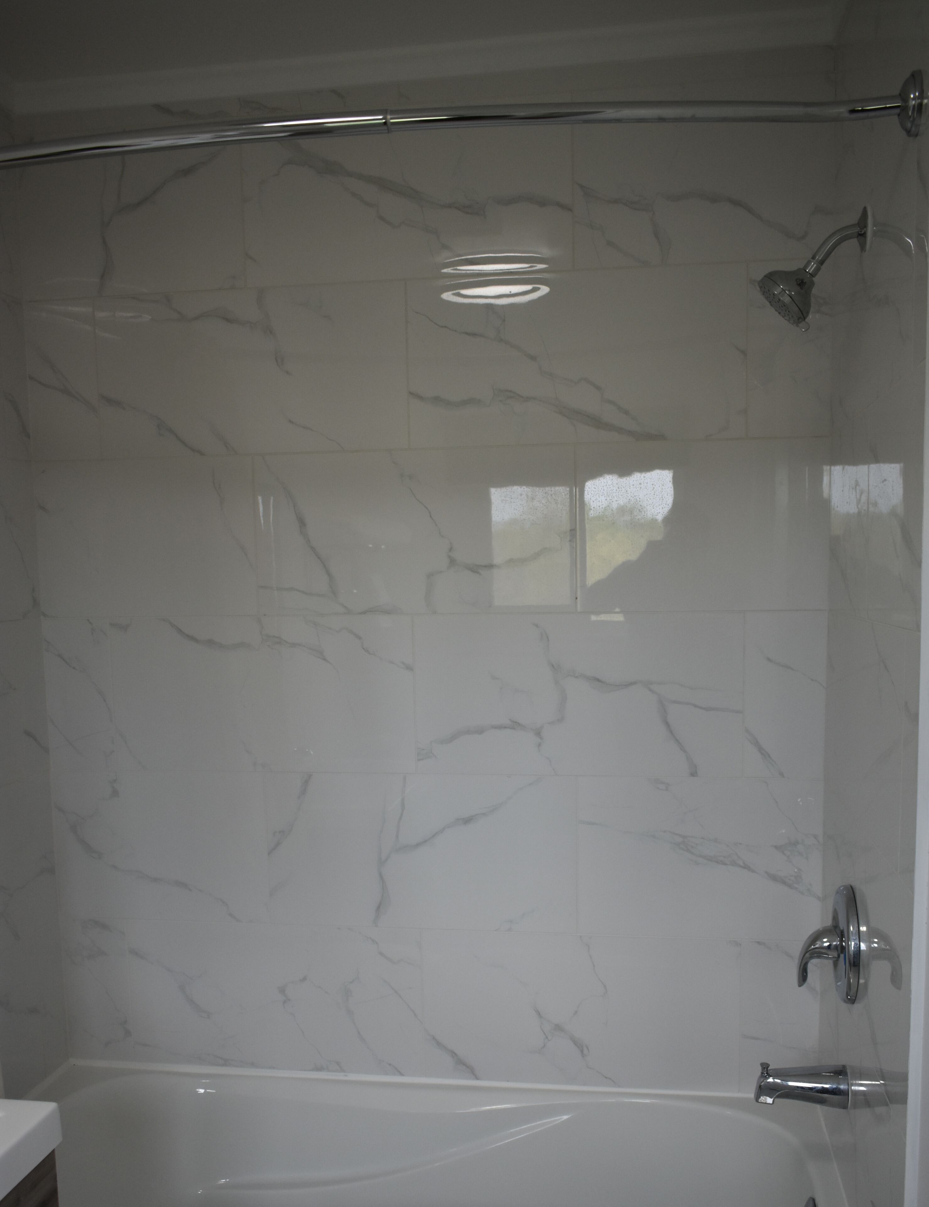 A bathroom with a shower, a bathtub, and a toilet.