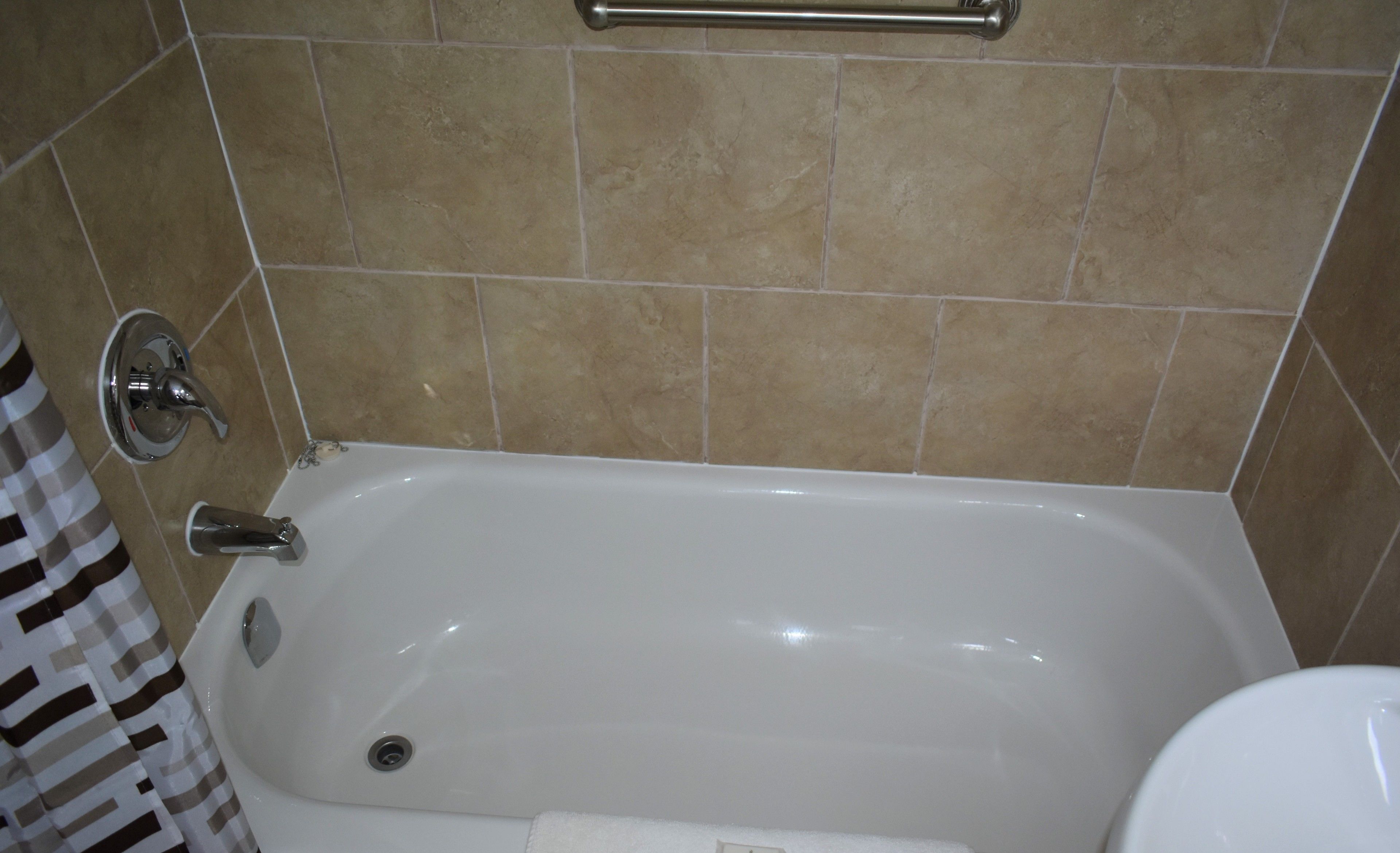 A bathroom with a bathtub, a shower, and a toilet.