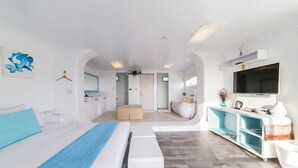A modern hotel room with a large bed, a seating area, a vanity, and a television. - Kenting South Border DeSign Hotel (Hengchun)
