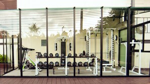 A gym with exercise equipment and weights.