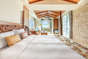 A spacious bedroom with a large bed, wooden headboard, and a view of a dining area through a glass door. - Kenting Shen's Homestay (Hengchun)