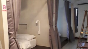 A room with a single bed, a ladder, and a curtain. - Chiangmai Gate Capsule Hostel (Chiang Mai)