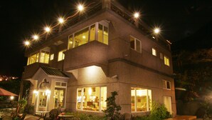 A multi-story building with outdoor seating and large windows. - Formosa Arcadian Villa (New Taipei City)