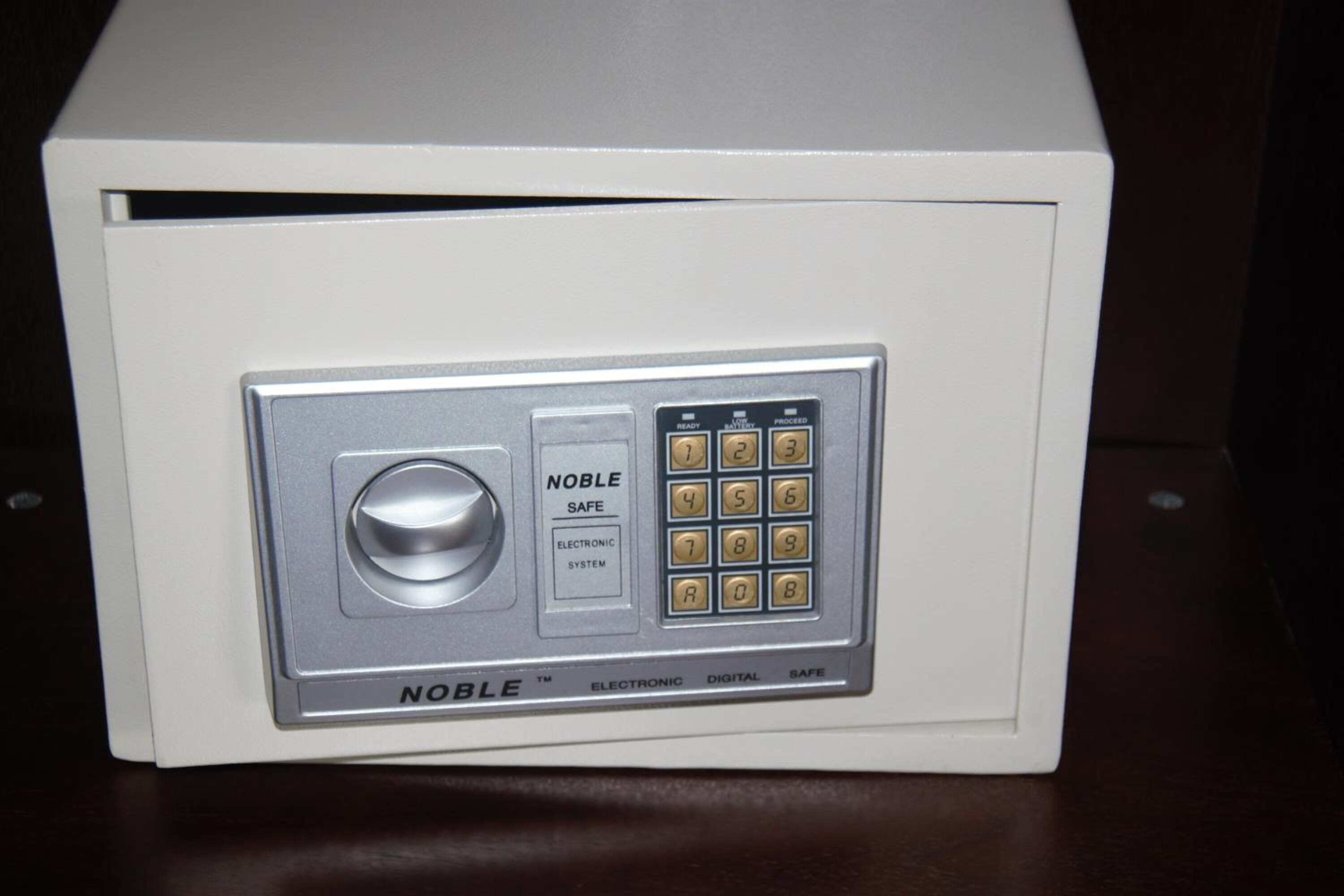 A safe with a keypad and a dial lock.