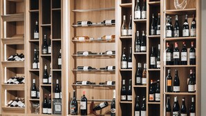 A wine cellar with wooden shelves and racks holding numerous wine bottles. - Suite Home Boutique Hotel (Phnom Penh)